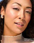 Model wearing Glowify Long-Lasting Eyeshadow Stick product shade Pink Luster.