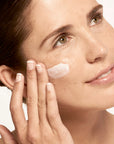 Model applying Microbiome Defense Daytime Moisturizer SPF 15.