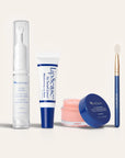 Ultimate Lip Care Collection NZL lineup with Lip Line Corrector in a tall clear pump, a white blue lip balm tube, a pink lip mask jar, and a blue handle applicator brush