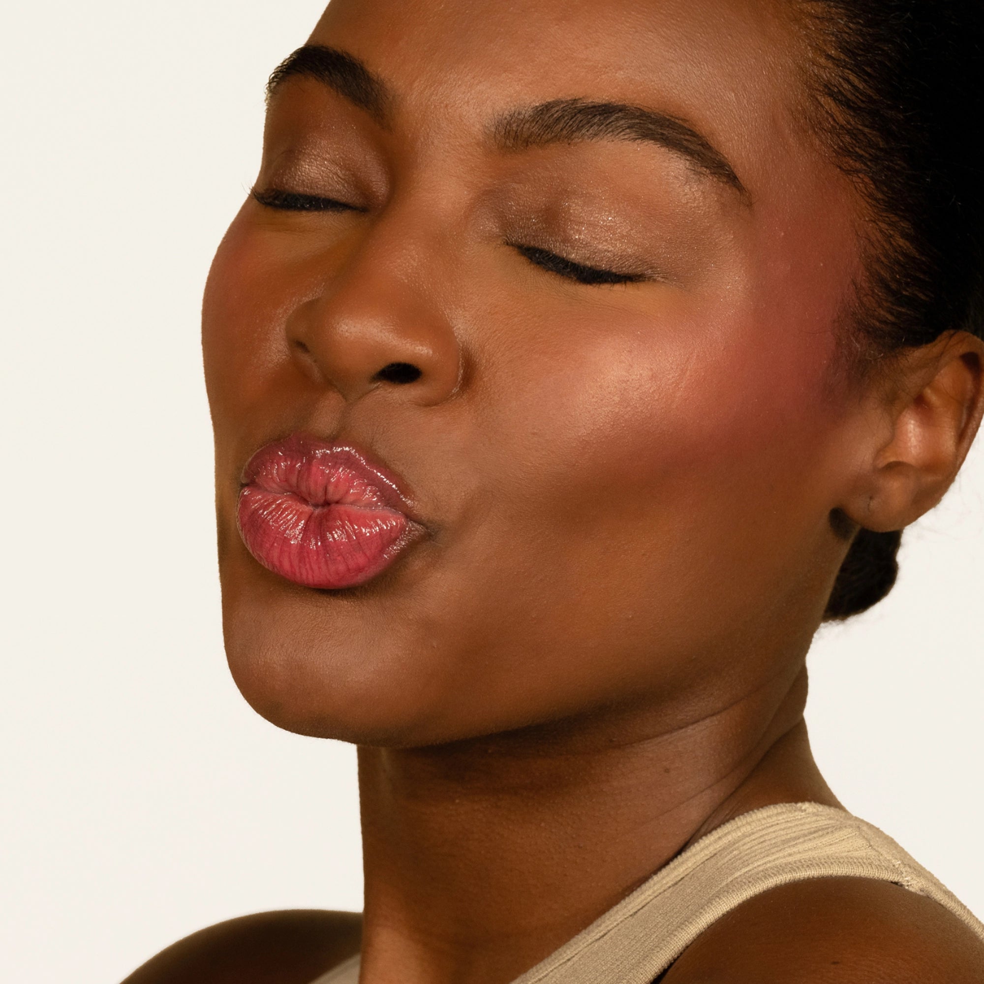 Model wearing Glowify Juicy Plumping Lip Gloss product shade Watermelon Pucker.