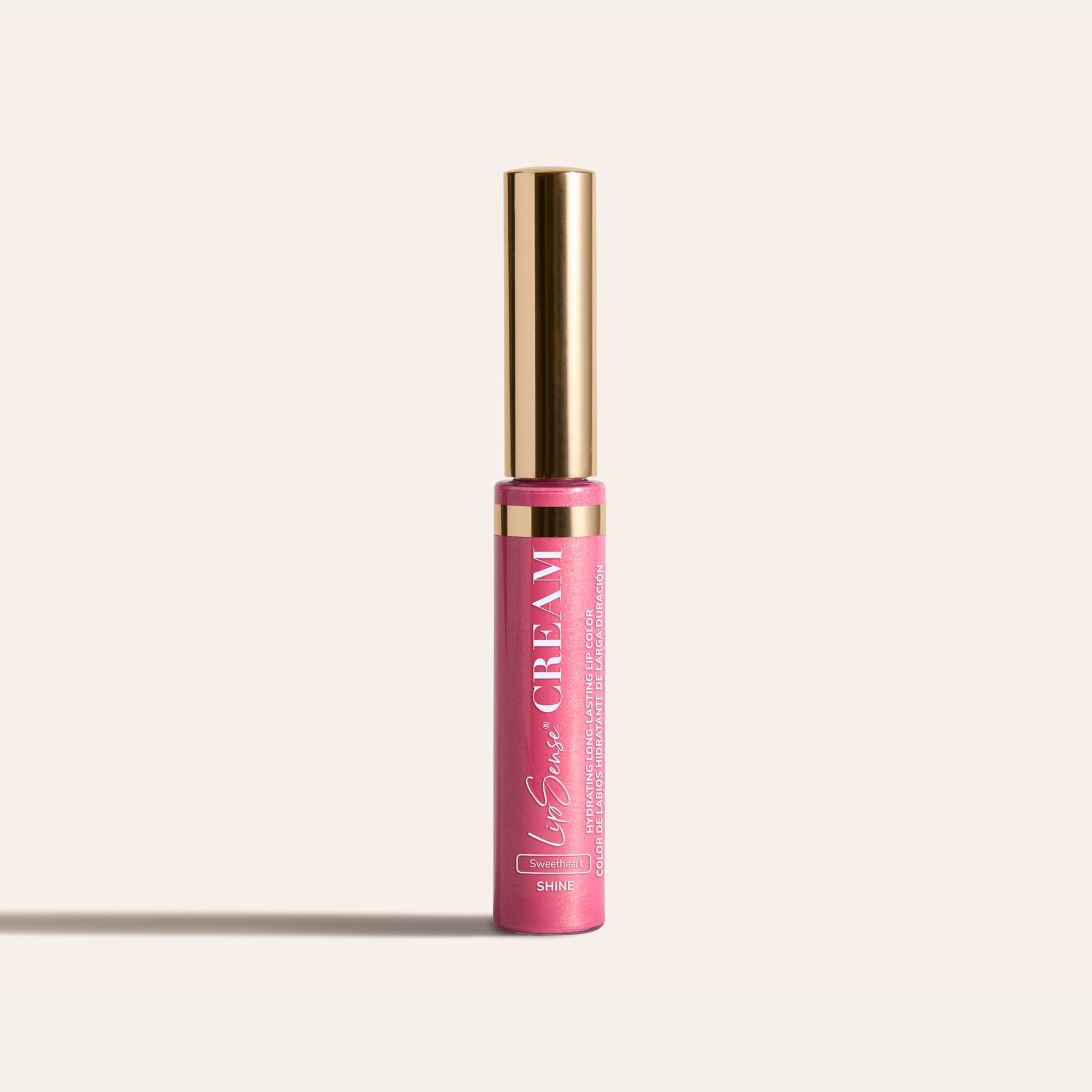 LipSense HydraMatte pink lip color bottle with a tall gold cap on a light beige background