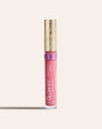 Pink sheer silk lip oil in a clear tube with a gold decorative cap standing upright