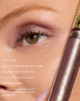 Close-up of eye with mauve pink shadow and a gold ornamental tube from Ethereal ShadowSense Duo CN.