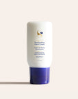 White Reactivating Hand Cream bottle with purple cap and Honey Ginger label on pale background