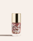 Shimmering pink glitter nail polish in a clear bottle with a gold cap